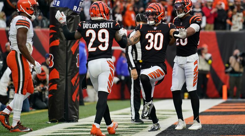 Cincinnati Bengals' Cam Taylor-Britt (29) and Jessie Bates III (30) celebrate stopping the Cleveland Browns during the second half of an NFL football game, Sunday, Dec. 11, 2022, in Cincinnati. (AP Photo/Jeff Dean)