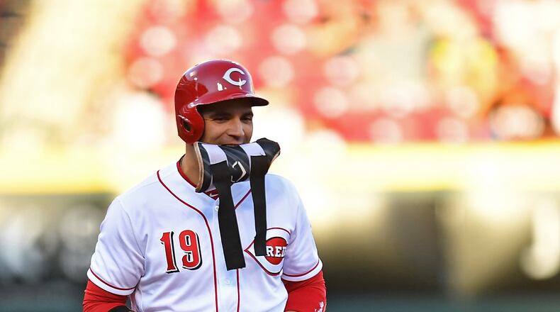 CINCINNATI, OH - AUGUST 9: Joey Votto #19 of the Cincinnati Reds removes his pad and gloves after hitting a double in the first inning against the San Diego Padres at Great American Ball Park on August 9, 2017 in Cincinnati, Ohio. (Photo by Jamie Sabau/Getty Images)
