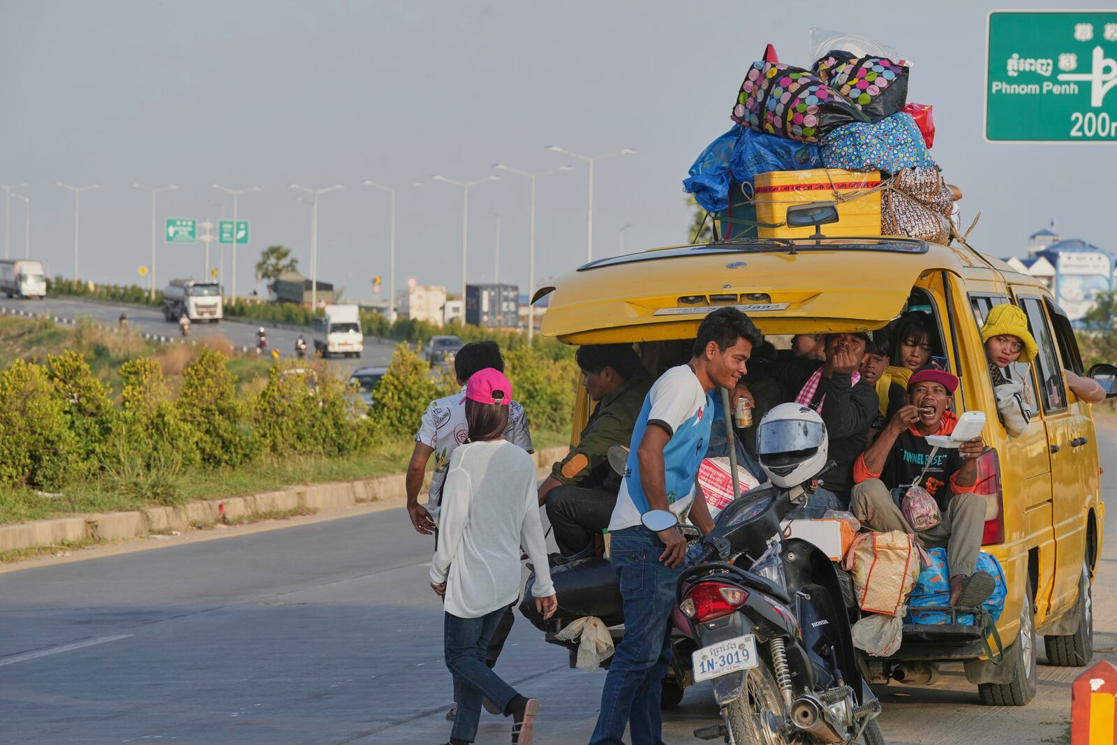 Cambodian garment workers heading to their home village to celebrate the traditional New Year holidays sit in an overcrowded van on the outskirts of Phnom Penh, Cambodia, Saturday, April 12. 2025. (AP Photo/Heng Sinith)
