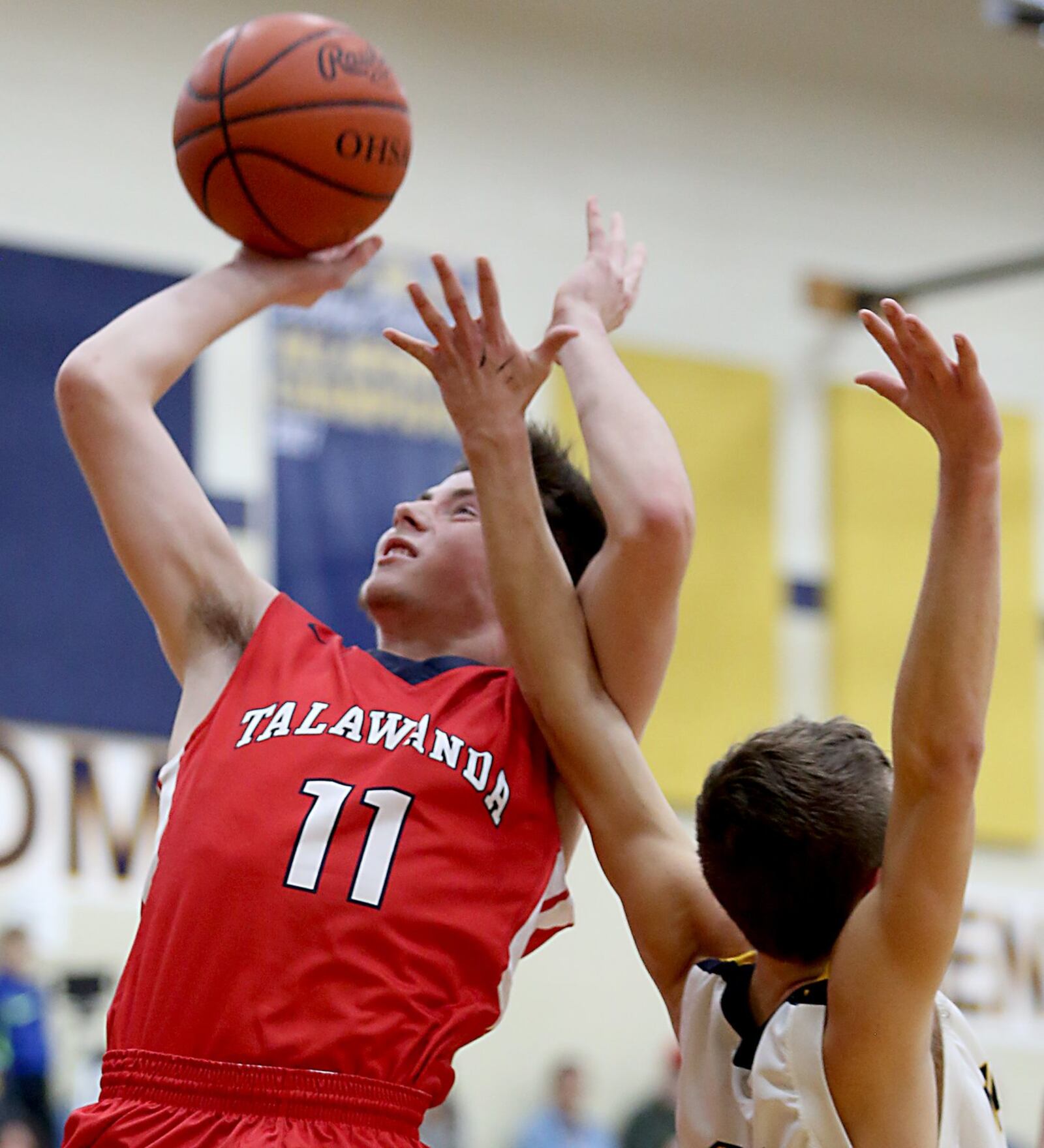 Talawanda’s Justin Boggs puts up a shot while being covered by Monroe guard Tucker Triplett during their game at Monroe on Tuesday night. CONTRIBUTED PHOTO BY E.L. HUBBARD