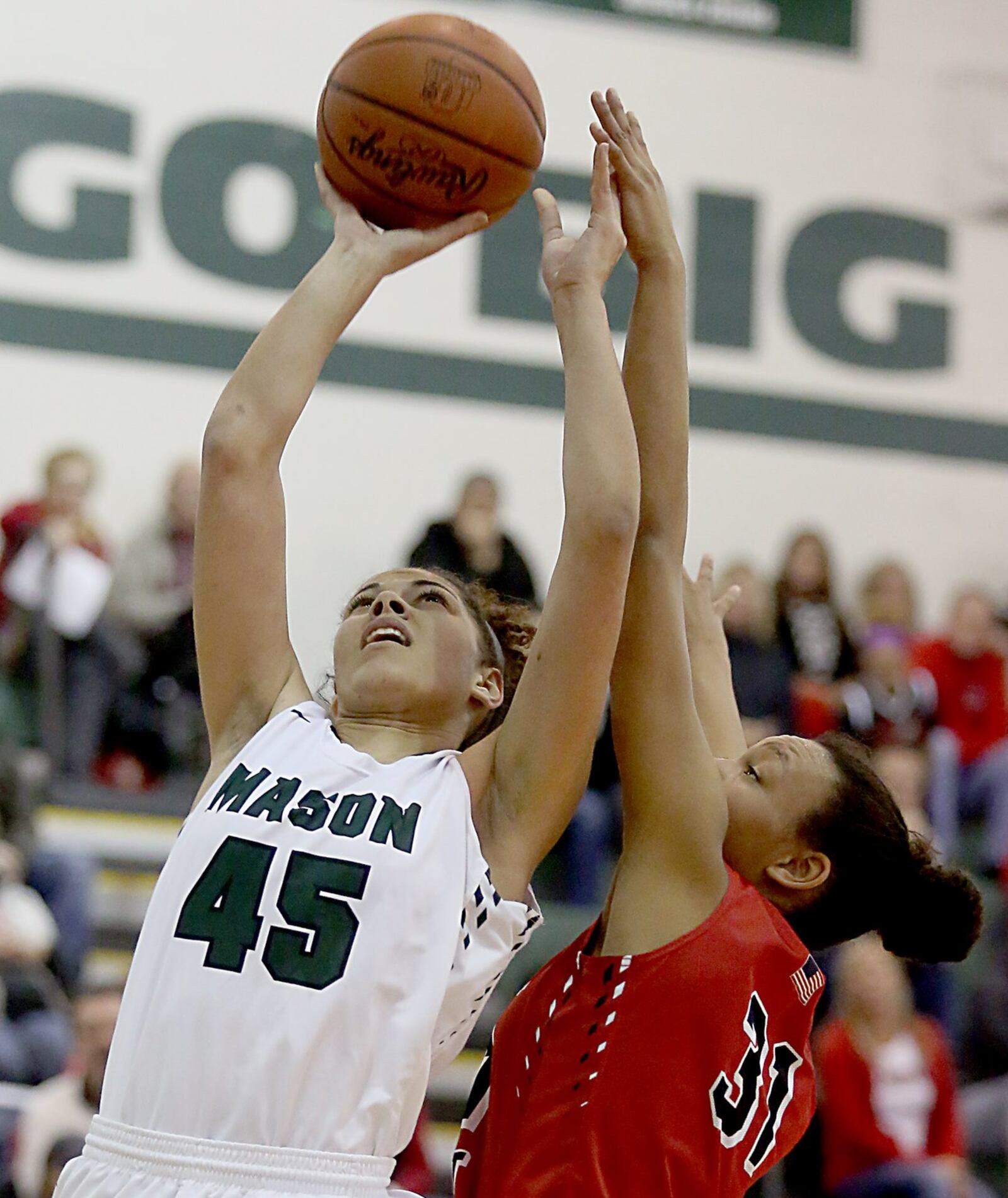 Mason’s Tihanna Fulton puts up a shot against Lakota West’s Nevaeh Dean during their game at the Mason Arena on Saturday afternoon. CONTRIBUTED PHOTO BY E.L. HUBBARD