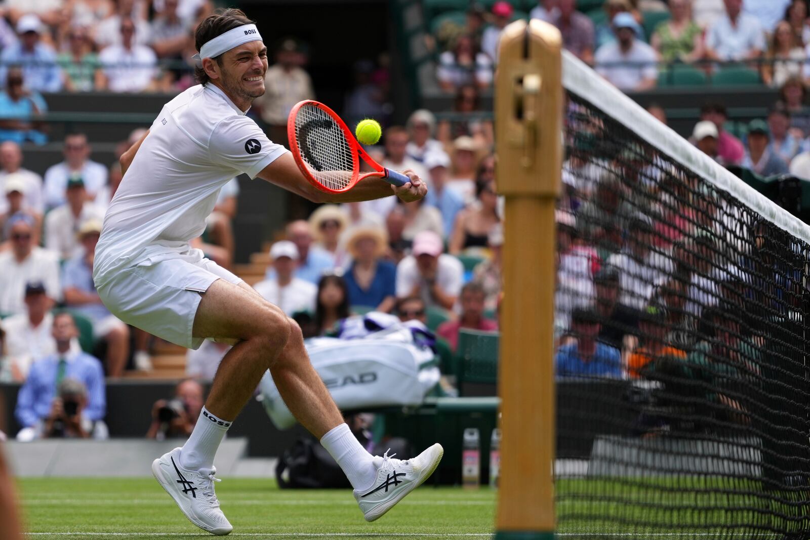 Taylor Fritz of the U.S. returns the ball to Giovanni Mpetshi Perricard of France during their first round men's singles match at the Wimbledon Tennis Championships in London, Tuesday, July 1, 2025.(AP Photo/Kirsty Wigglesworth)