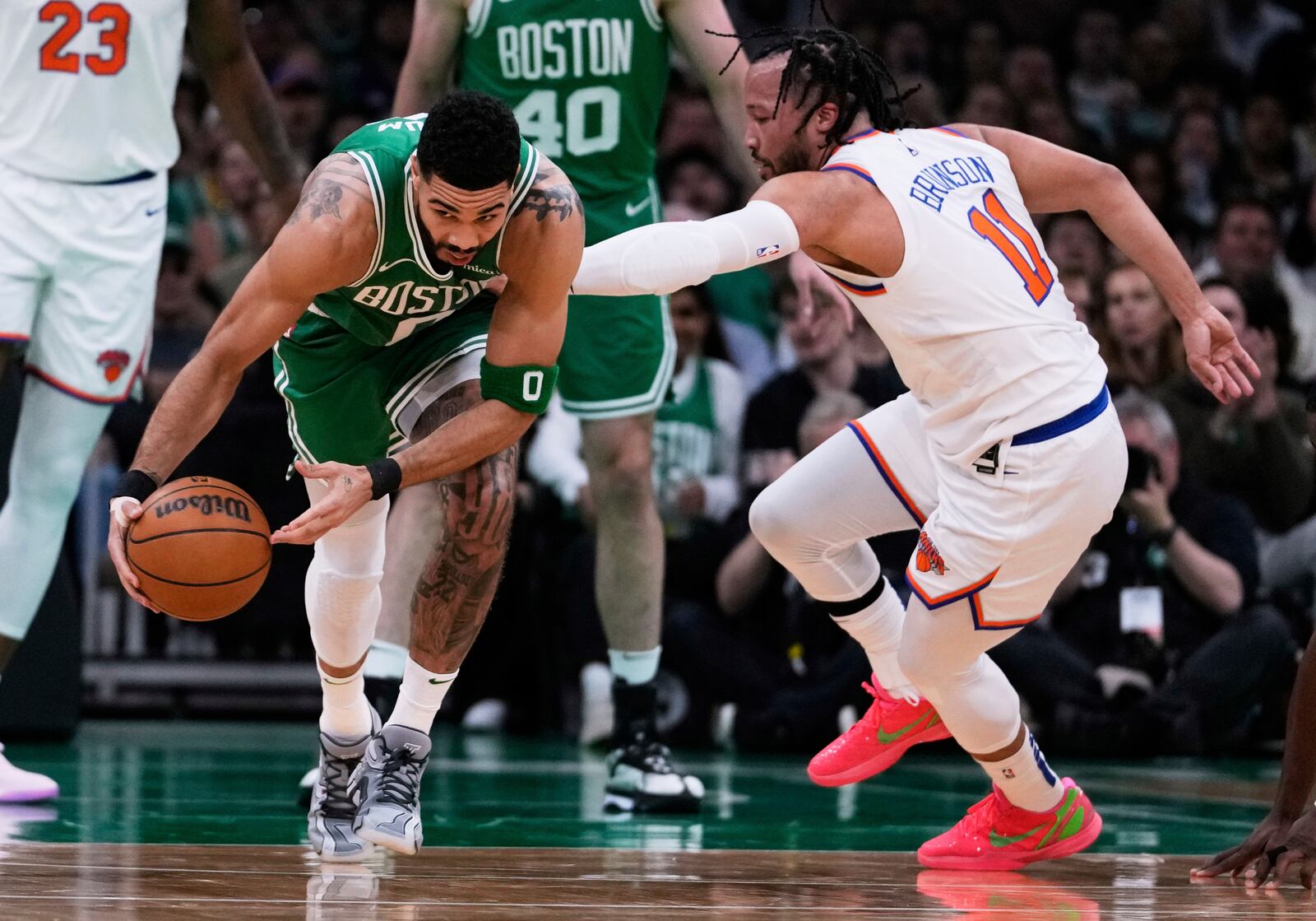 Boston Celtics forward Jayson Tatum, left, grabs a loose ball against New York Knicks guard Jalen Brunson (11) during the first half of Game 2 of an NBA basketball second-round playoff series, Wednesday, May 7, 2025, in Boston. (AP Photo/Charles Krupa)