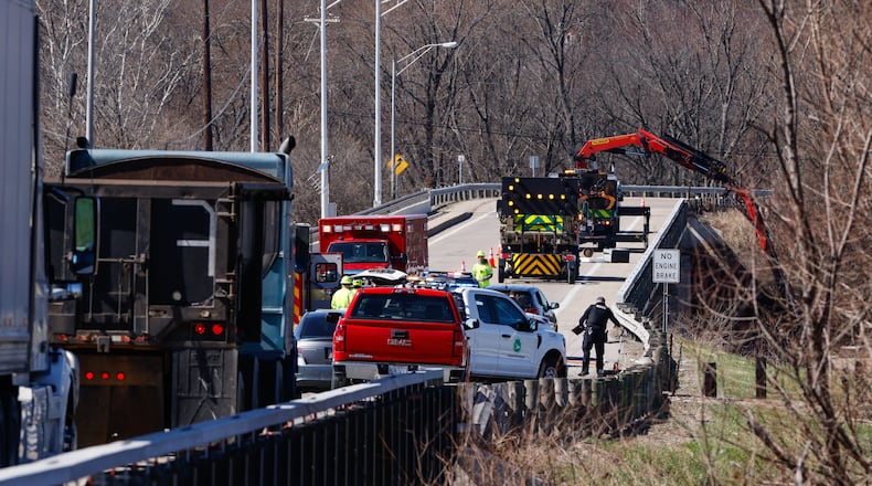 Middletown Fire Department responds to the Ohio 122 bridge in Middletown to take two pedestrians struck by a vehicle to an area hospital. Ohio Department of Transportation crews had the bridge reduced to one lane, with flaggers positioned on both sides while they were cleaning debris from the river. NICK GRAHAM/STAFF