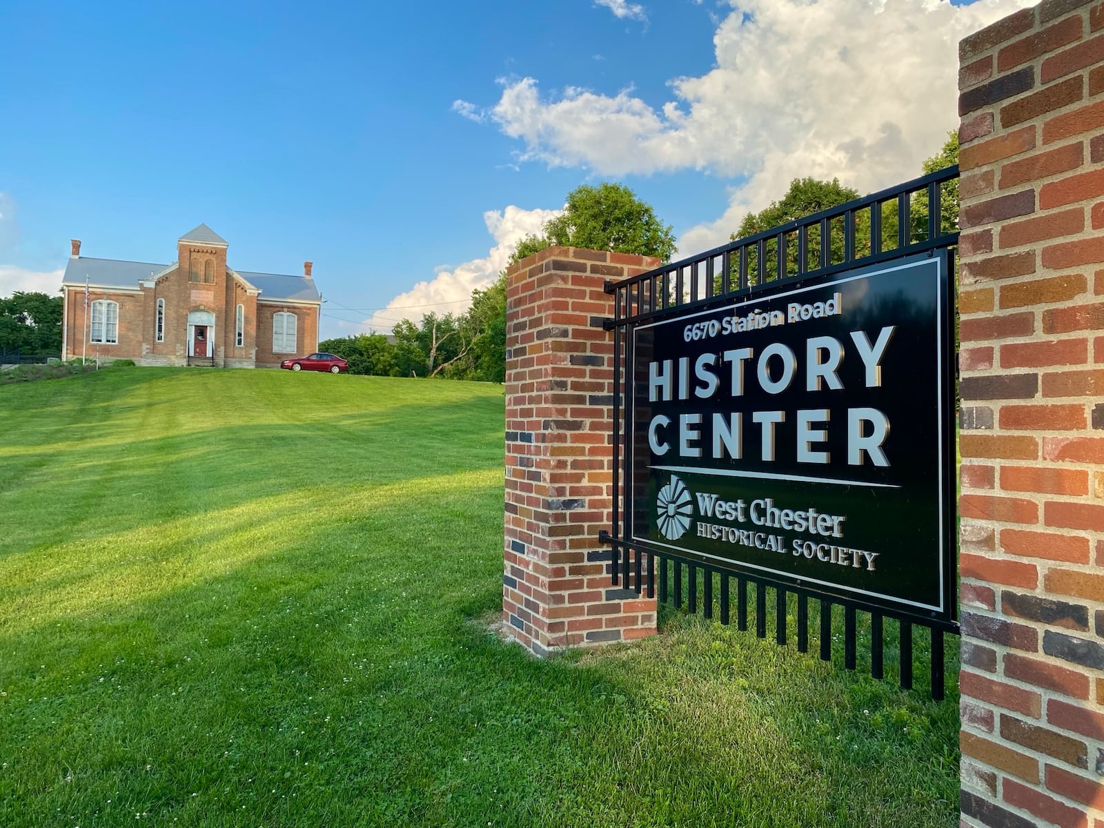 A new, historically themed garden is now open at the site of one of West Chester Twp.’s oldest school buildings.
The former Station Road school house’s campus features a walk-through garden display – including a giant bison statue, horse-drawn wagon, last-century wind mill – showcasing native flowers and other plants from the township’s past. (Photo by Michael D. Clark/Journal-News)