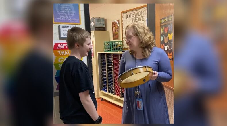 The world of music is being opened to special needs students at a Lakota school through a choir director’s collaboration with their teacher. Thanks to a fellow teacher, Jennifer Akers at Hopewell Junior School (pictured with student) saw an opportunity and took on the extra work to set up instrumental music lessons for the students and the reactions have been overwhelmingly positive, say Lakota officials. (Provided Photo\Journal-News)