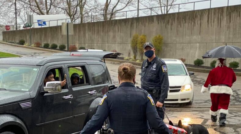 As part of its Mike Davis Shop with a Cop program, Middletown police officers and staff shopped for 24 local families with 62 children. The department held a drive-through gift distribution due to the coronavirus. SUBMITTED PHOTO