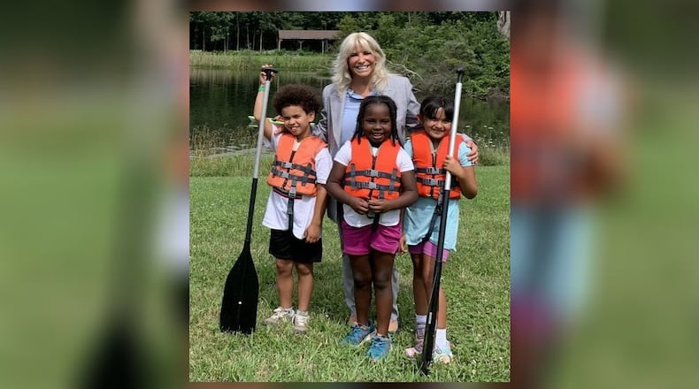 Ohio Rep. Sarah Carruthers was one of several donors who helped raise money to replace five stolen canoes, associated equipment and a trailer. Pictured is Carruthers with three of the YMCA campers at the Hughes Summer Camp at Camp Campbell Gard on Augspurger Road. PROVIDED