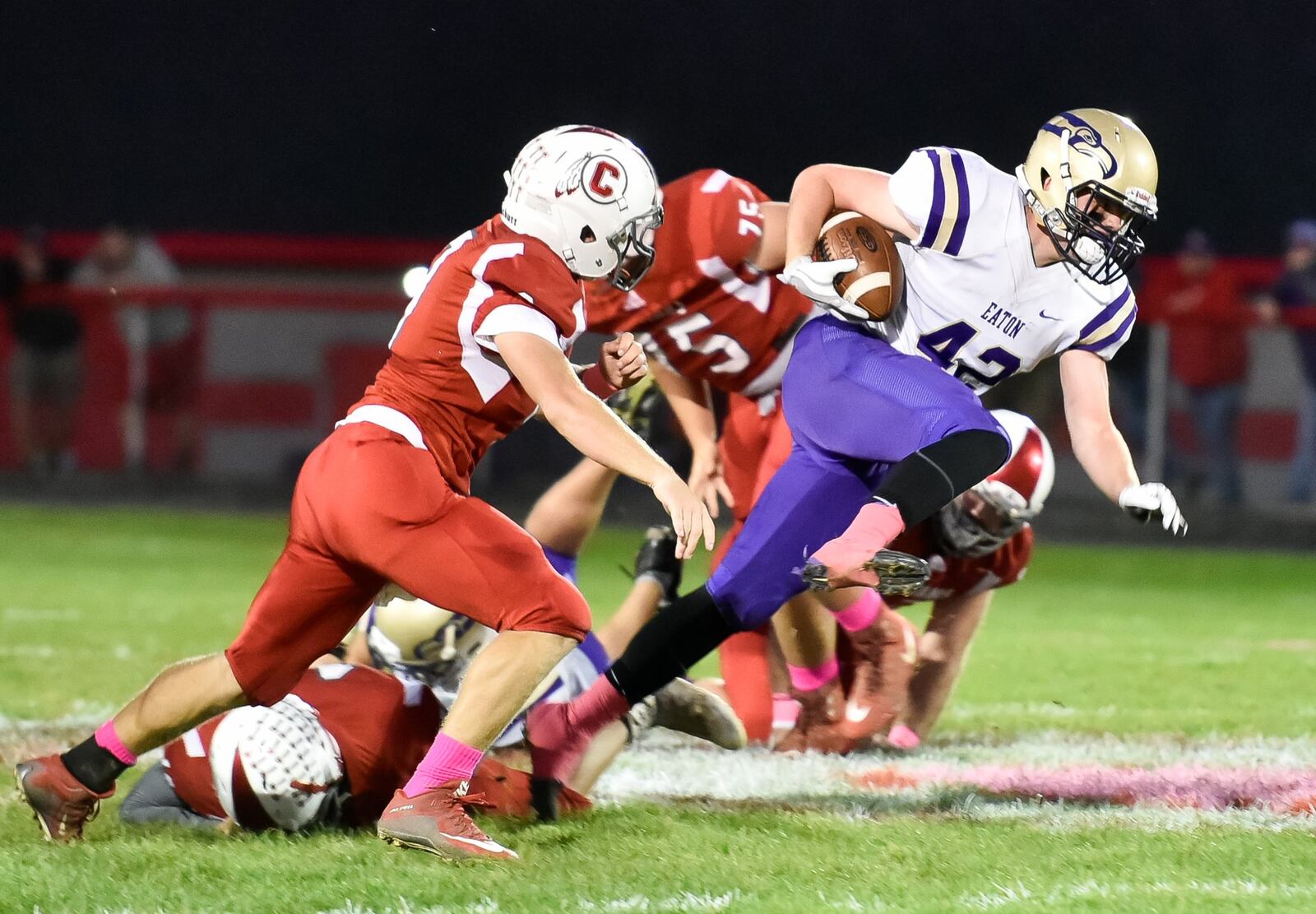 Eaton’s Caleb Puckett makes a move through the Carlisle defense Thursday night at Laughlin Field in Carlisle. NICK GRAHAM/STAFF