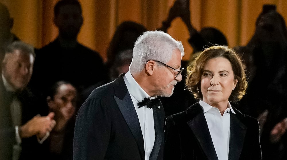 FILE - Armani Chairman Pantaleo Dell’Orco, left, and Giorgio Armani's niece Silvana Armani acknowledge the applause at the end of the Giorgio Armani Spring/Summer 2026 collection show in Milan, Italy, Sunday, Sept. 28, 2025. (AP Photo/Luca Bruno, File)