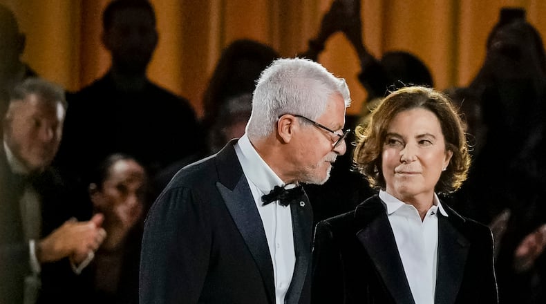 FILE - Armani Chairman Pantaleo Dell’Orco, left, and Giorgio Armani's niece Silvana Armani acknowledge the applause at the end of the Giorgio Armani Spring/Summer 2026 collection show in Milan, Italy, Sunday, Sept. 28, 2025. (AP Photo/Luca Bruno, File)