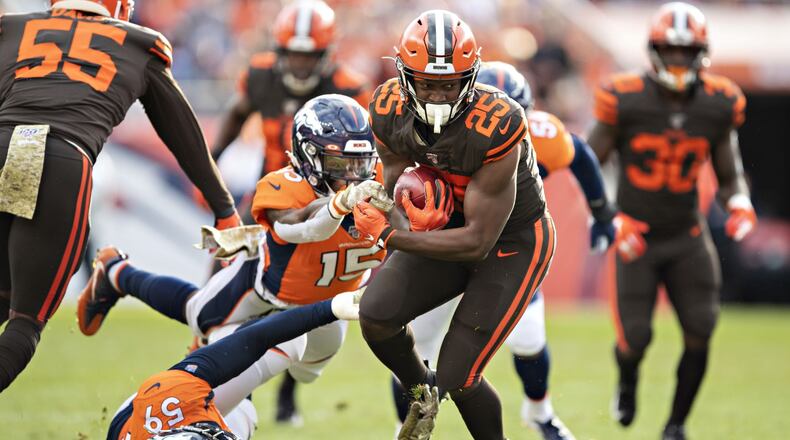 DENVER, CO - NOVEMBER 3: Montreal Hilliard #25 of the Cleveland Browns runs the ball and is hit by Juwann Winfree #15 and Malik Reed #59 of the Denver Broncos during the first half at Broncos Stadium at Mile High on November 3, 2019 in Denver, Colorado. (Photo by Wesley Hitt/Getty Images)