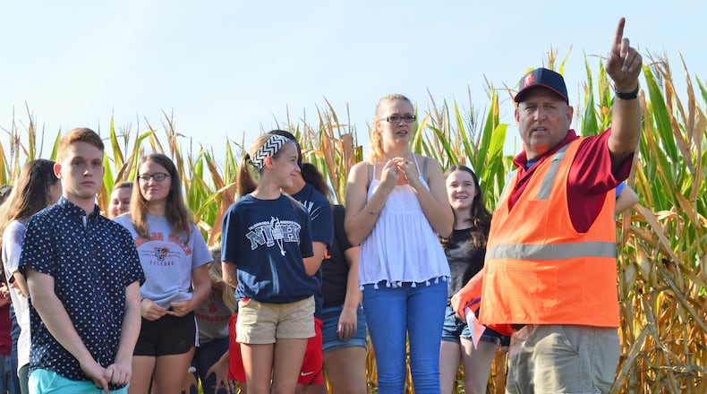 Talawanda Director of Transportation Mike Sokol instructs students to where they need to go following the simulated bus crash emergency drill. CONTRIBUTED/BOB RATTERMAN
