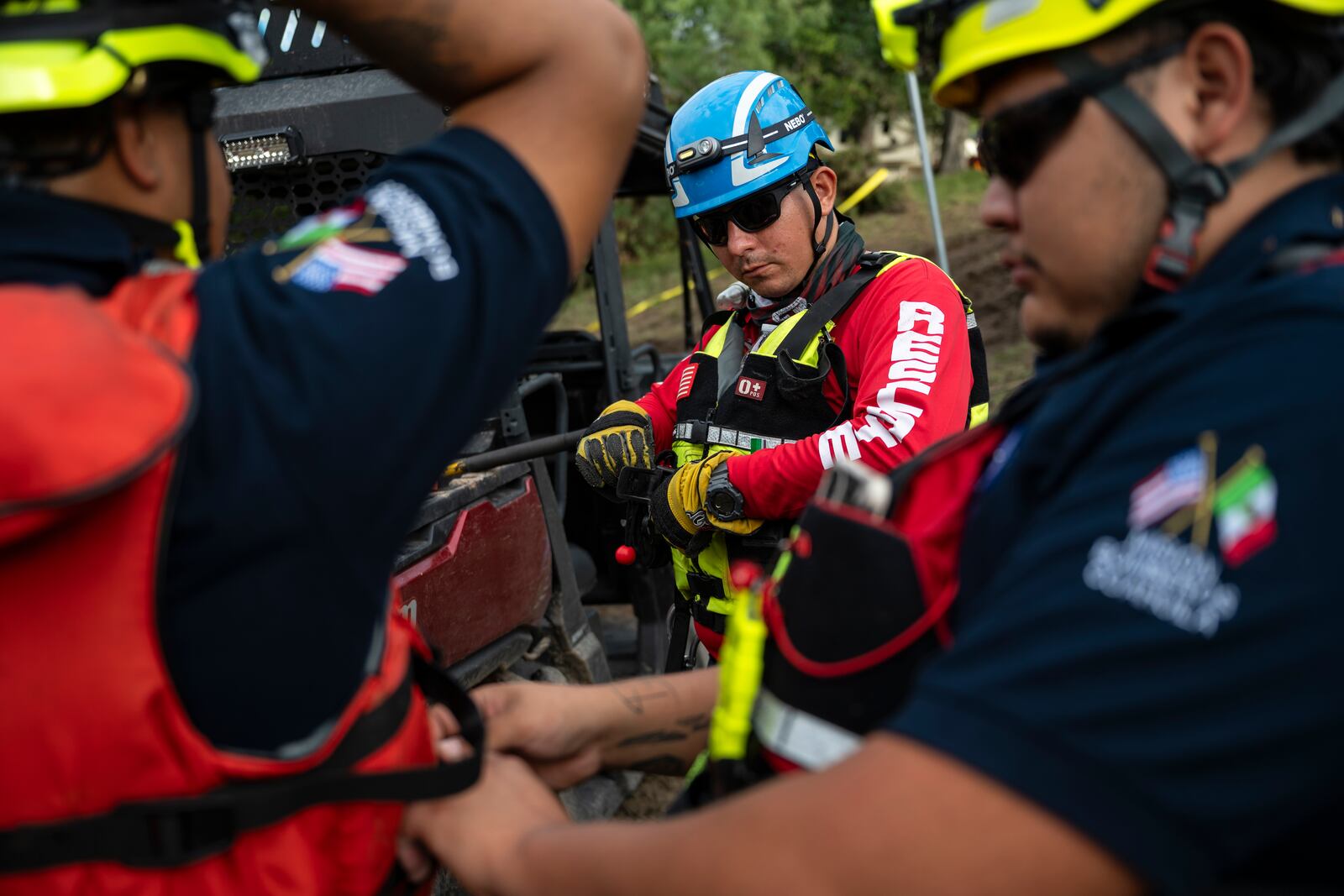 A crew of firefighters from Ciudad Acuna gather for a briefing as they aid in search and rescue efforts near the Guadalupe River after a flash flood swept through the area Monday, July 7, 2025, in Ingram, Texas. (AP Photo/Eli Hartman)