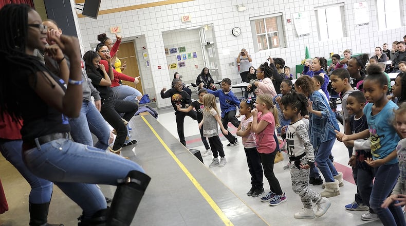Children in the Lincoln Elementary Promise Neighborhood program try to keep up with a group of Wilberforce University fraternity and sorority members demonstrating “Step Dancing” Wednesday. Bill Lackey/Staff