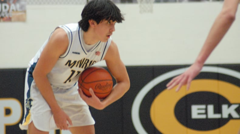 Monroe senior Noah Fults looks for a passing lane against Xenia in a Division I sectional contest on Wednesday at Centerville. Fults bucketed a team-high 21 points. Chris Vogt/CONTRIBUTED
