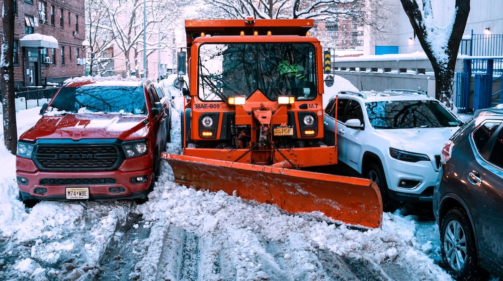 A truck removes snow for them street a day after a winter storm on Tuesday, Feb. 24, 2026, in New York. (AP Photo/Eduardo Munoz Alvarez)