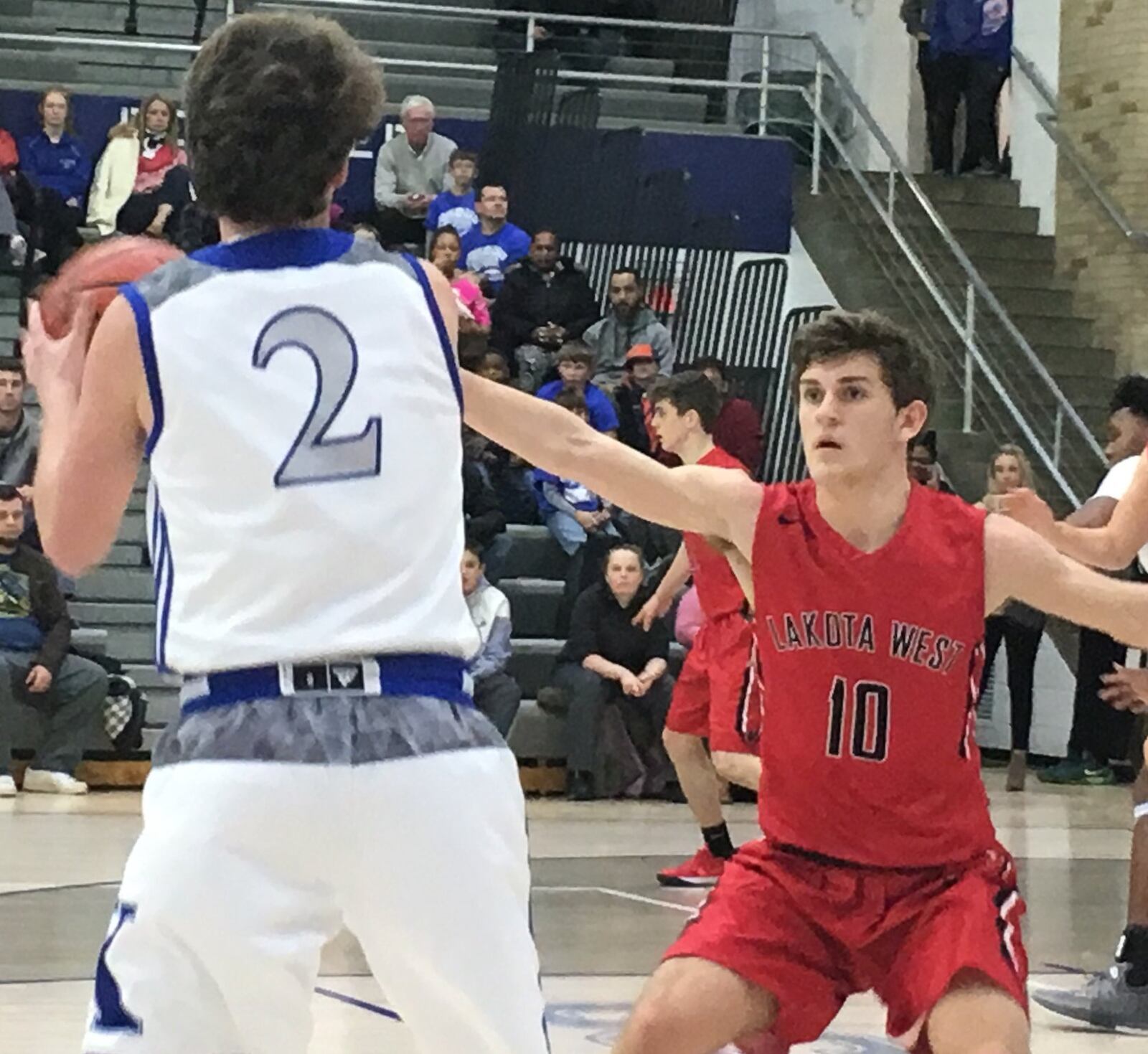 Lakota West’s Bradley Groth (10) guards Nathan Gleckler (2) of St. Xavier during a Jan. 16 game at Berning Gym in Springfield Township. RICK CASSANO/STAFF