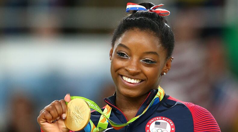 Gold medalist Simone Biles of the United States celebrates on the podium at the medal ceremony for the Women’s Floor on Day 11 of the Rio 2016 Olympic Games at the Rio Olympic Arena on August 16, 2016 in Rio de Janeiro, Brazil. (Photo by Alex Livesey/Getty Images)