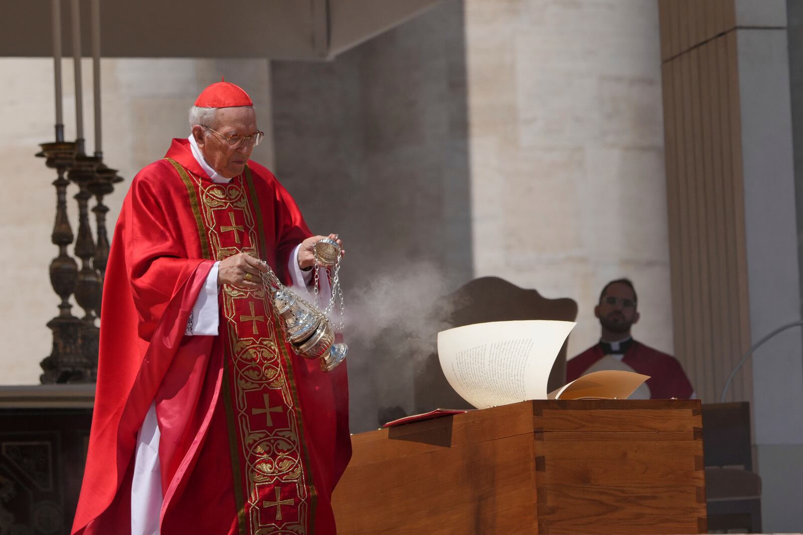 Dean of the College of Cardinals Giovanni Battista Re blesses the coffin during the funeral of Pope Francis in St. Peter's Square at the Vatican, Saturday, April 26, 2025. (AP Photo/Alessandra Tarantino)