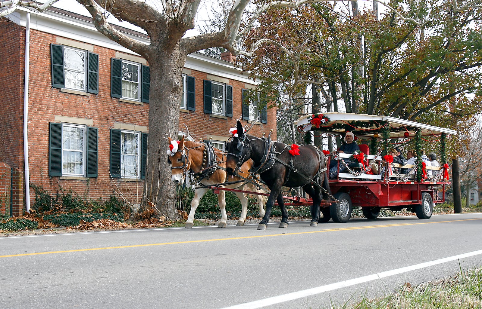 A horse drawn trolley makes its way through Shandon, Ohio as part of the village's 32nd annual Old Fashioned Christmas in the Country celebration Saturday Nov. 29, 2008.