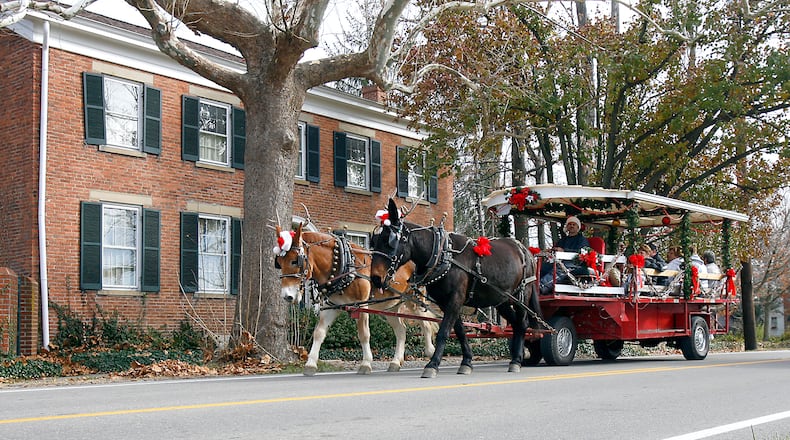 A horse drawn trolley makes its way through Shandon, Ohio as part of the village's 32nd annual Old Fashioned Christmas in the Country celebration Saturday Nov. 29, 2008.