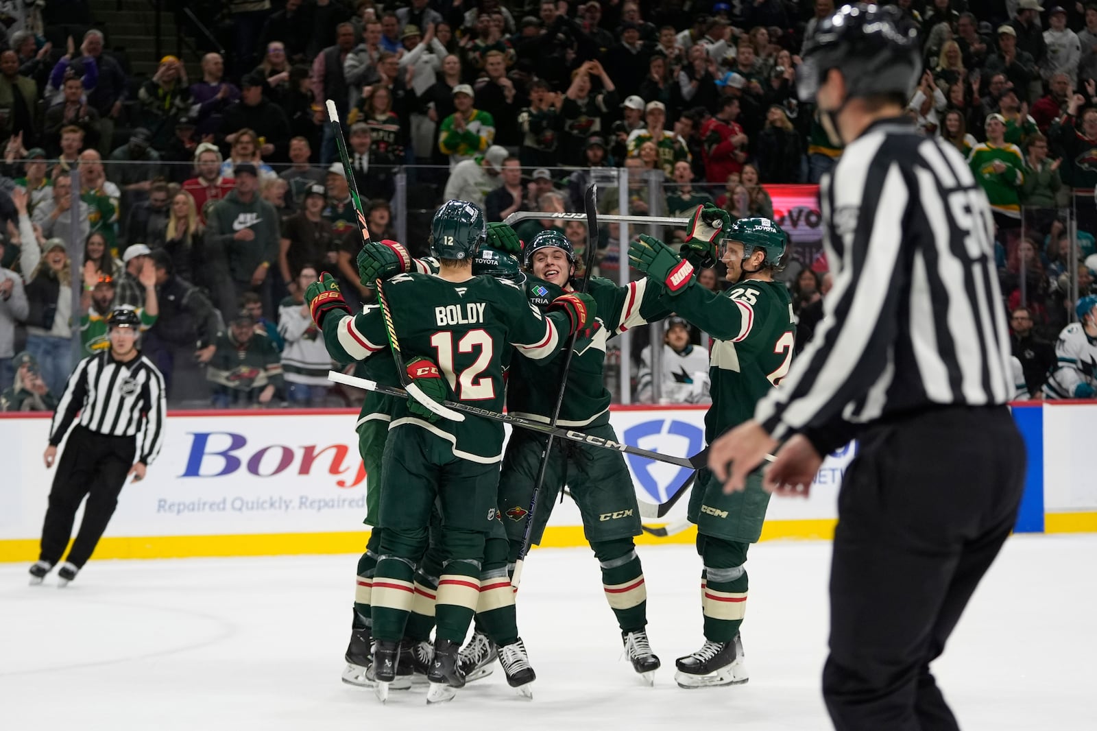 Minnesota Wild defenseman Brock Faber (7), back, center, celebrates with teammates after scoring a goal during the first period of an NHL hockey game against the San Jose Sharks, Wednesday, April 9, 2025, in St. Paul, Minn. (AP Photo/Abbie Parr)