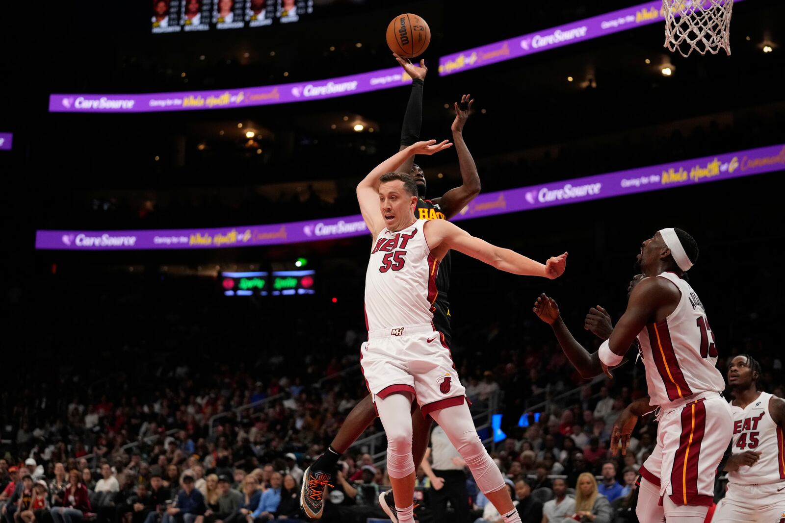 Miami Heat forward Duncan Robinson (55) attempts to block the ball against in the first half of an NBA play-in tournament basketball game against the Friday, April 18, 2025, in Atlanta. (AP Photo/Brynn Anderson)