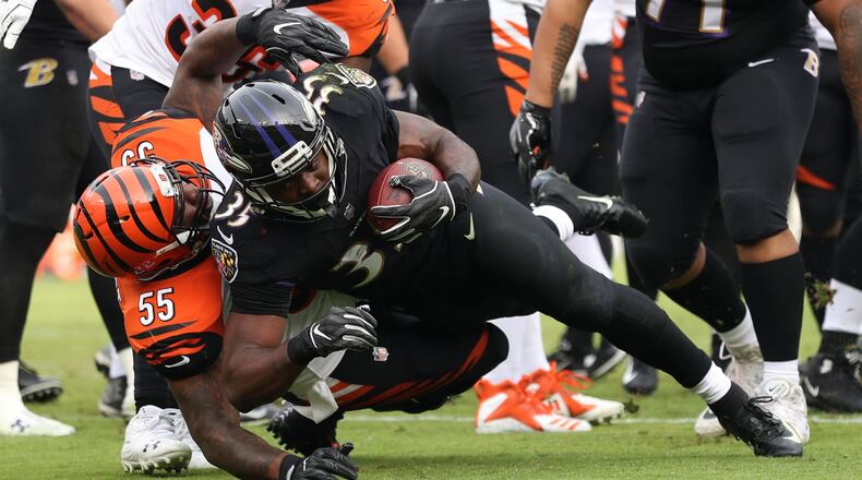 BALTIMORE, MD - NOVEMBER 18: Running Back Gus Edwards #35 of the Baltimore Ravens runs with the ball as he is tackled by outside linebacker Vontaze Burfict #55 of the Cincinnati Bengals in the second quarter at M&T Bank Stadium on November 18, 2018 in Baltimore, Maryland. (Photo by Patrick Smith/Getty Images)