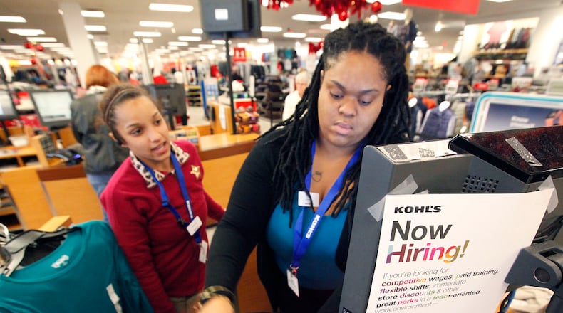 Kohl’s employee Mariah Nooks, left, helps new hire Zaria Carson as she scans items for a customer at the Centerville store. There’s still time to jump on the holiday job train, with retailers, distribution centers and fulfillment centers looking to hire thousands in the Dayton area as the peak of the holiday shopping season rapidly approaches. With low unemployment and increasing online sales, an increase in seasonal jobs is being seen across the board, though many positions could go unfilled with the number of permanent open jobs. TY GREENLEES / STAFF