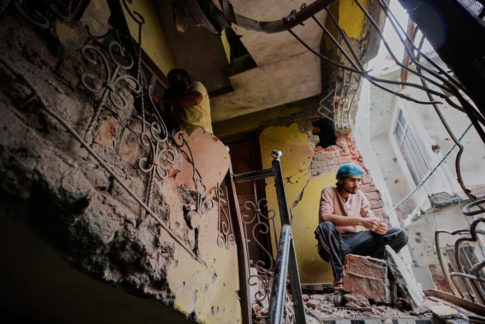 A person sits in his house damaged by Pakistani artillery shelling in Poonch, along the Line of Control, Indian controlled Kashmir, Thursday, May 8, 2025. (AP Photo/Channi Anand)