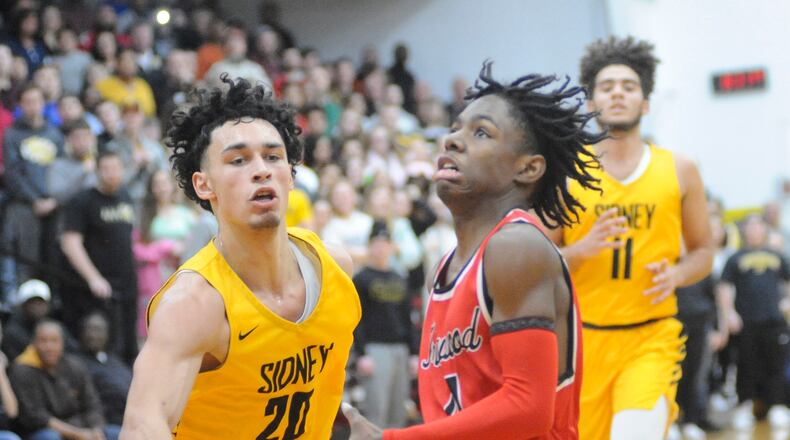 Sophomore Carter Mims of Trotwood-Madison (with ball) gets past Andre Gordon of Sidney during the visiting Rams’ 90-69 win on Friday, Jan. 18, 2019. MARC PENDLETON / STAFF