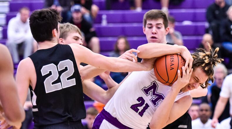 Middletown’s Chris Stallworth (21) and Lakota East’s Bash Wieland (22) fight for the ball during Tuesday night’s game at Wade E. Miller Arena in Middletown. East won 61-47. NICK GRAHAM/STAFF