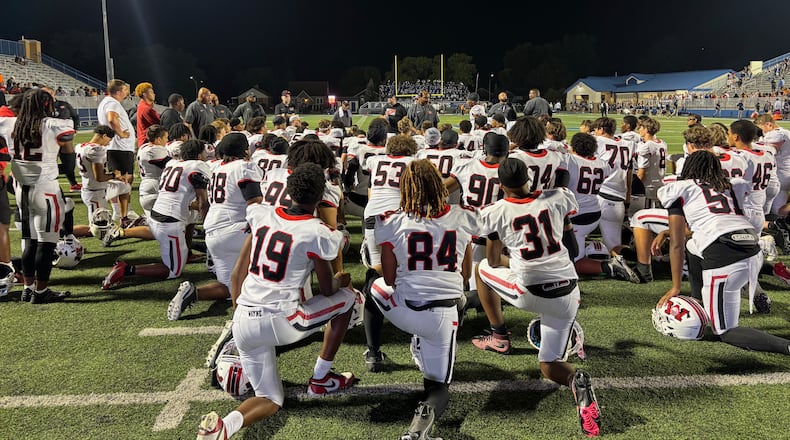 Wayne listens to coach Roosevelt Mukes after a victory against Fairmont on Friday, Sept. 19, 2025, at Roush Stadium in Kettering. David Jablonski/Staff