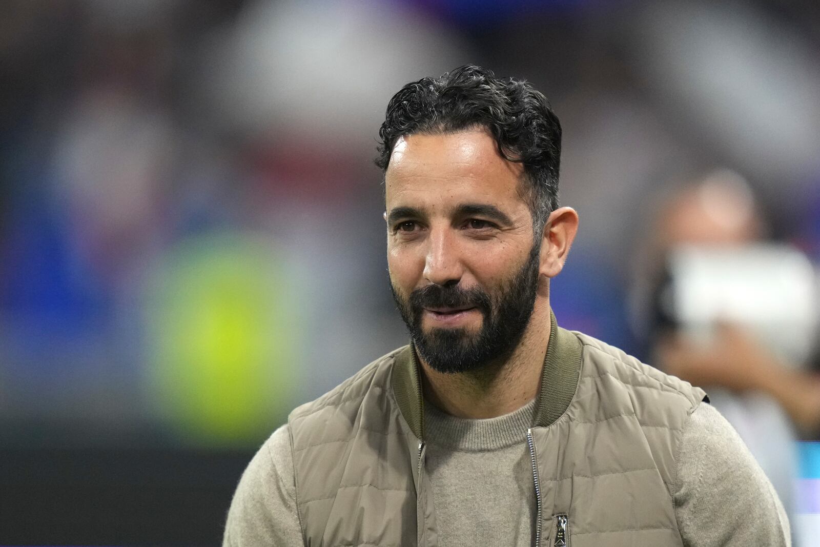 Manchester United's head coach Ruben Amorim smiles before the Europa League quarterfinal first leg soccer match between Lyon and Manchester United at Groupama stadium in Decines, outside Lyon, France, Thursday, April 10, 2025. (AP Photo/Thibault Camus)