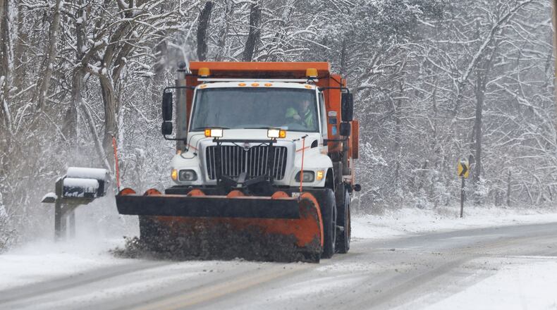 A Butler County snow plow is shown on Elk Creek Road in Madison Twp. on a snowy Friday morning, Jan. 19, 2024. The weather affected schools and businesses. NICK GRAHAM/STAFF