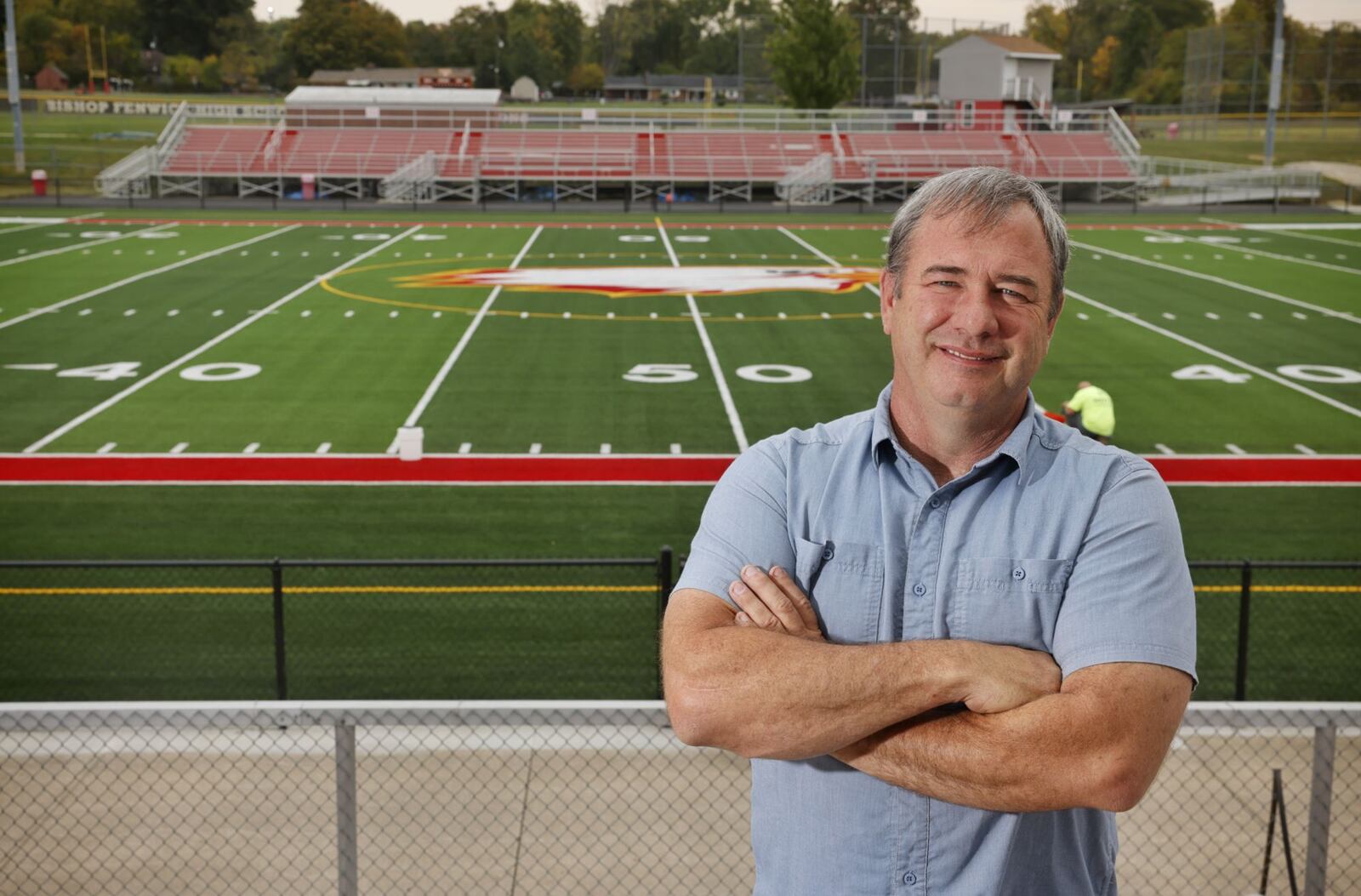 Chester Yeager stands in front of the new turf at Fenwick's Yeager Field. The Yeager family donated money for the new turf field and other improvements for the school. NICK GRAHAM/STAFF