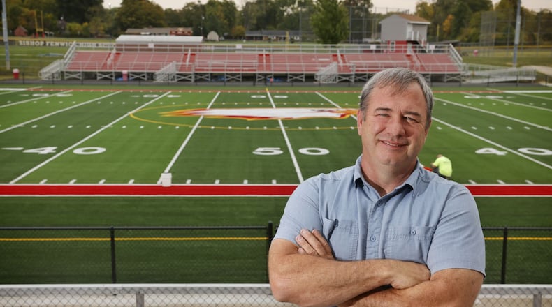 Chester Yeager stands in front of the new turf at Fenwick's Yeager Field. The Yeager family donated money for the new turf field and other improvements for the school. NICK GRAHAM/STAFF