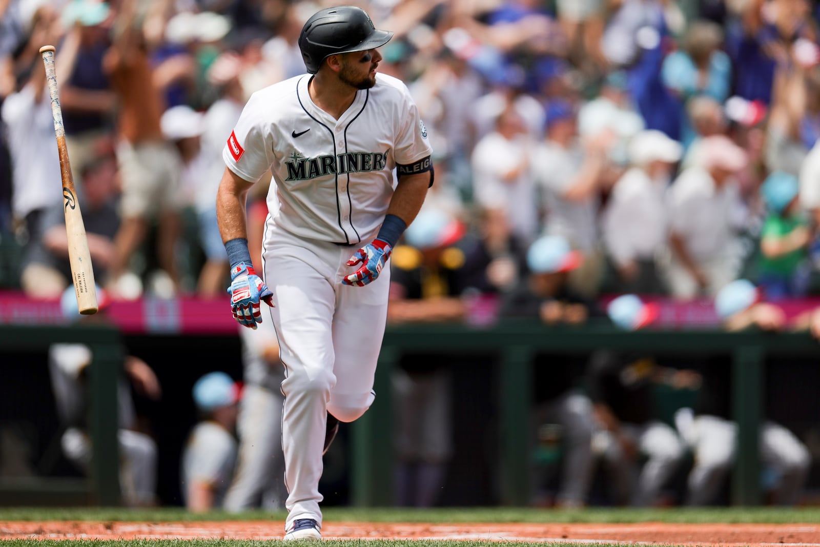 Seattle Mariners designated hitter Cal Raleigh tosses his bat after hitting a two-run home run during the first inning of a baseball game against the Pittsburgh Pirates, Friday, July 4, 2025, in Seattle. (AP Photo/Ryan Sun)