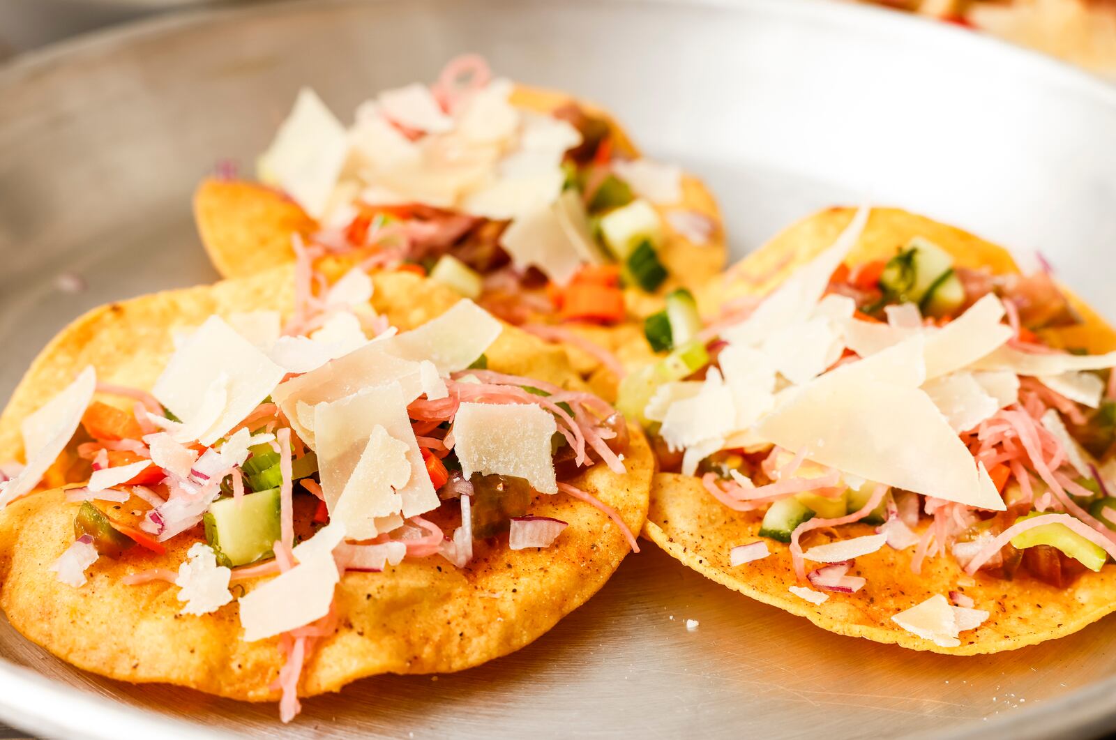 Todd Hudson, owner and chef at Wildflower Cafe in Mason, shows some creative dishes to add variety while packing school lunches for students. This a batch of veggie tostadas. NICK GRAHAM/STAFF