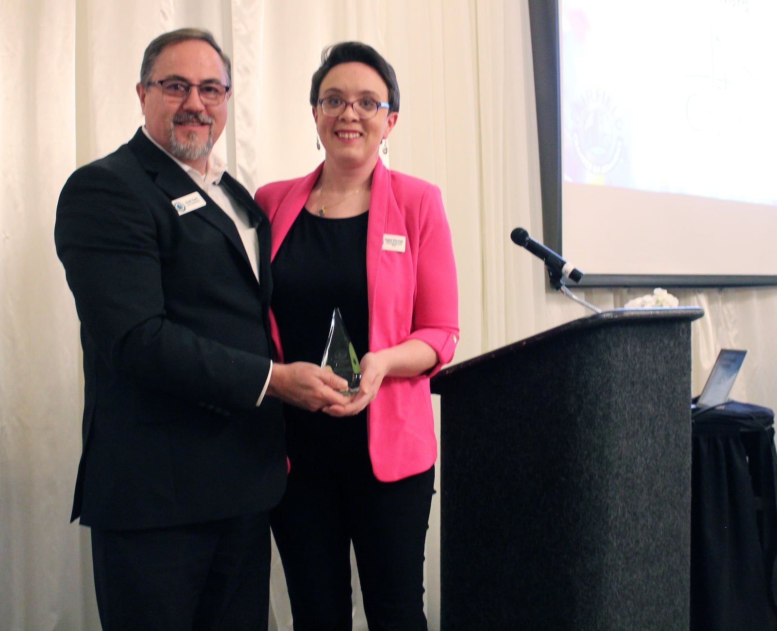Scott Clark presented the Fairfield Chamber of Commerce's Pinnacle of Business Award to Angela Scrumpf, with The Cincinnati Insurance Companies. SUE KIESEWETTER/CONTRIBUTED