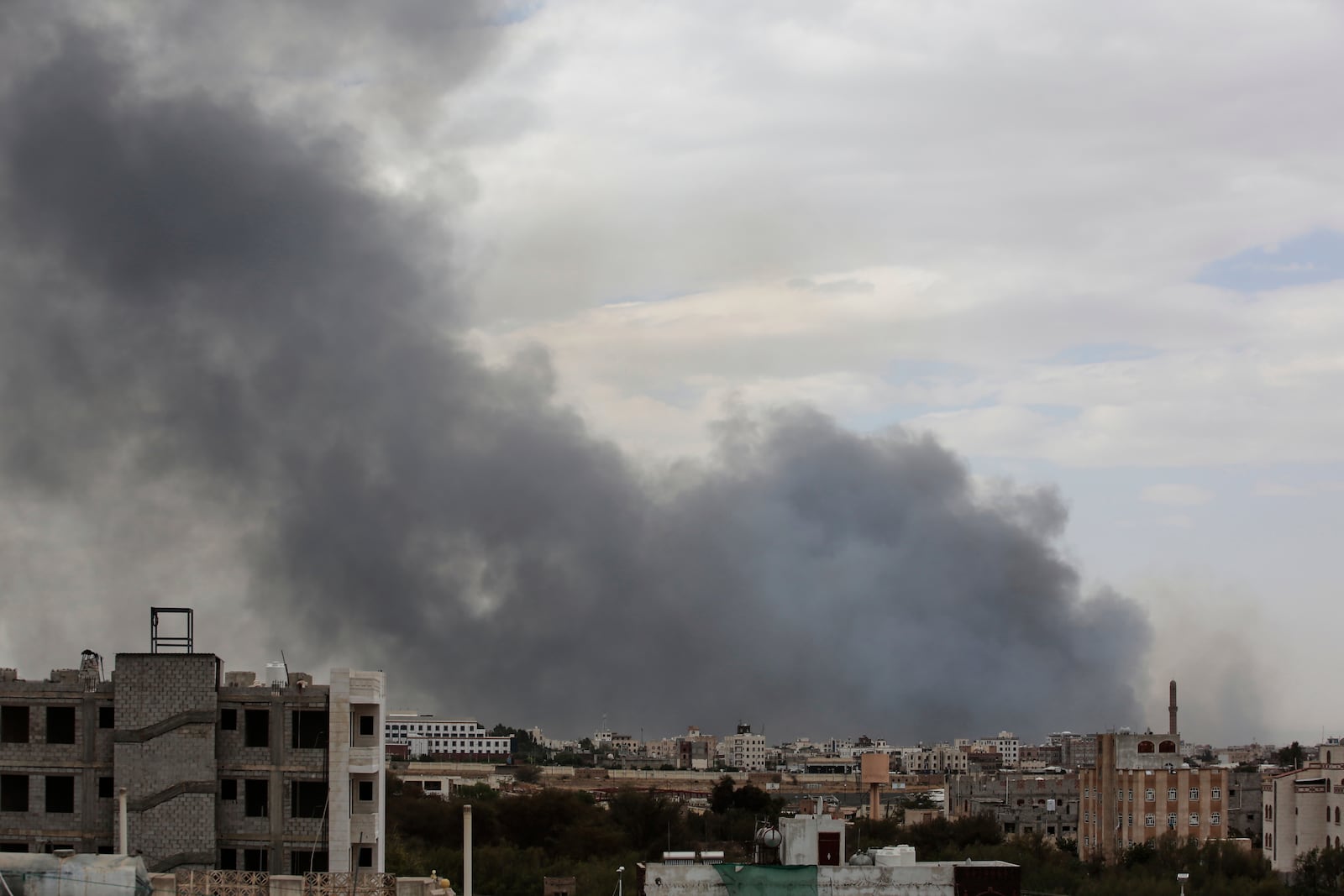 Smoke billows following Israeli airstrikes targeting a power plant and Sanaa Airport, in Sanaa, Yemen, Tuesday, May 6, 2025. (AP Photo/Osamah Abdulrahman)
