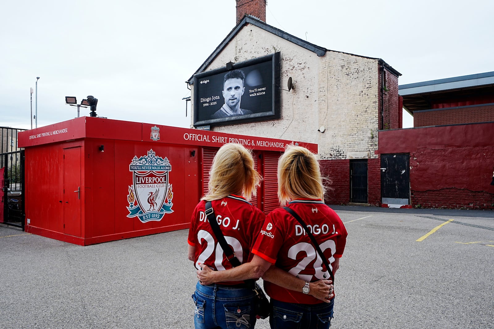 Liverpool supporters wearing shirts in memory of Diogo Jota at Anfield Stadium, home of Liverpool, who has died at the age of 28, in Liverpool, England, Friday July 4, 2025. (Peter Byrne/PA via AP)
