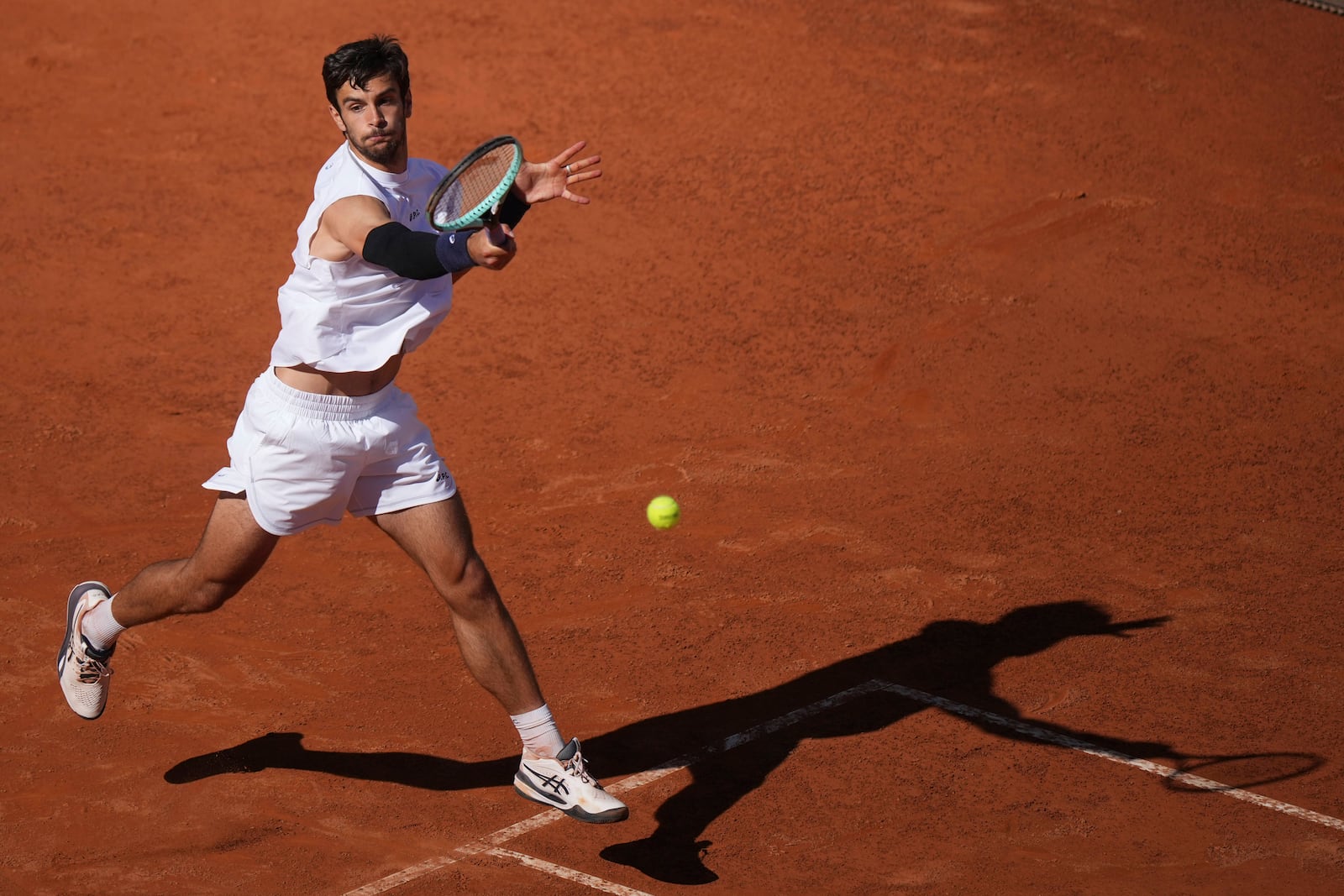 Italy's Lorenzo Musetti returns the ball to Spain's Carlos Alcaraz during their semifinal tennis match at the Italian Open, in Rome, Friday, May 16, 2025. (AP Photo/Andrew Medichini)