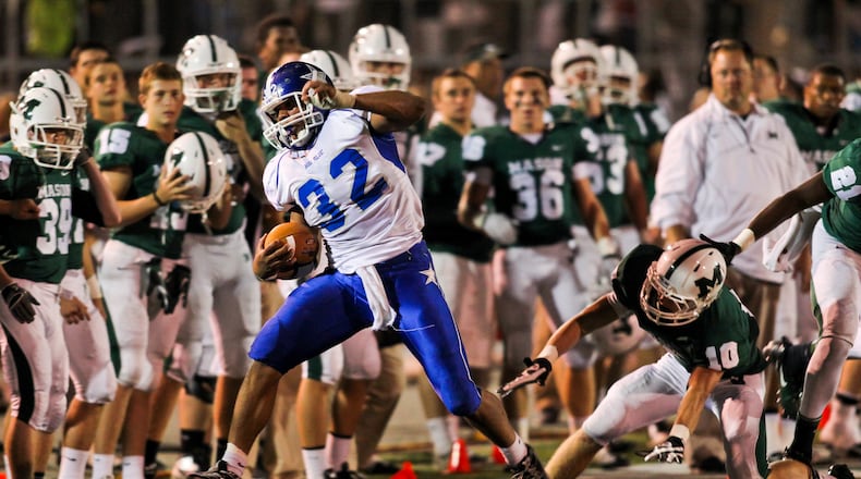 Hamilton's Marcus Oliver (32) is pushed out of bounds during Friday night's game against Mason at Mason High School Sept. 21, 2012. Staff photo by Nick Daggy