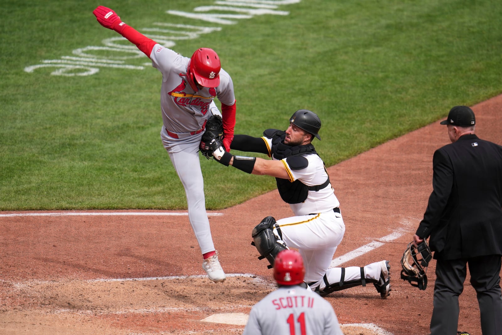 St. Louis Cardinals' Michael Siani, left, is tagged out by Pittsburgh Pirates catcher Joey Bart during the 10th inning of a baseball game in Pittsburgh, Wednesday, April 9, 2025. (AP Photo/Gene J. Puskar)