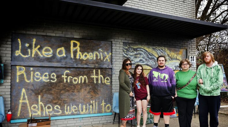 A fire destroyed Lucid Ink Tattoo and attached apartments on Millard Drive in Franklin. Residents were able to escape but a cat, Toriyama, died in the fire. Lara Crutchfield, left, owns the building and tattoo shop, and escaped with her daughter, Jacelyn and son Nicholas (Not Pictured). Jason Kuhn, middle, lived in the other apartment with his sister, Libby Kuhn and her boyfriend, Daniel Snider, right. NICK GRAHAM/STAFF