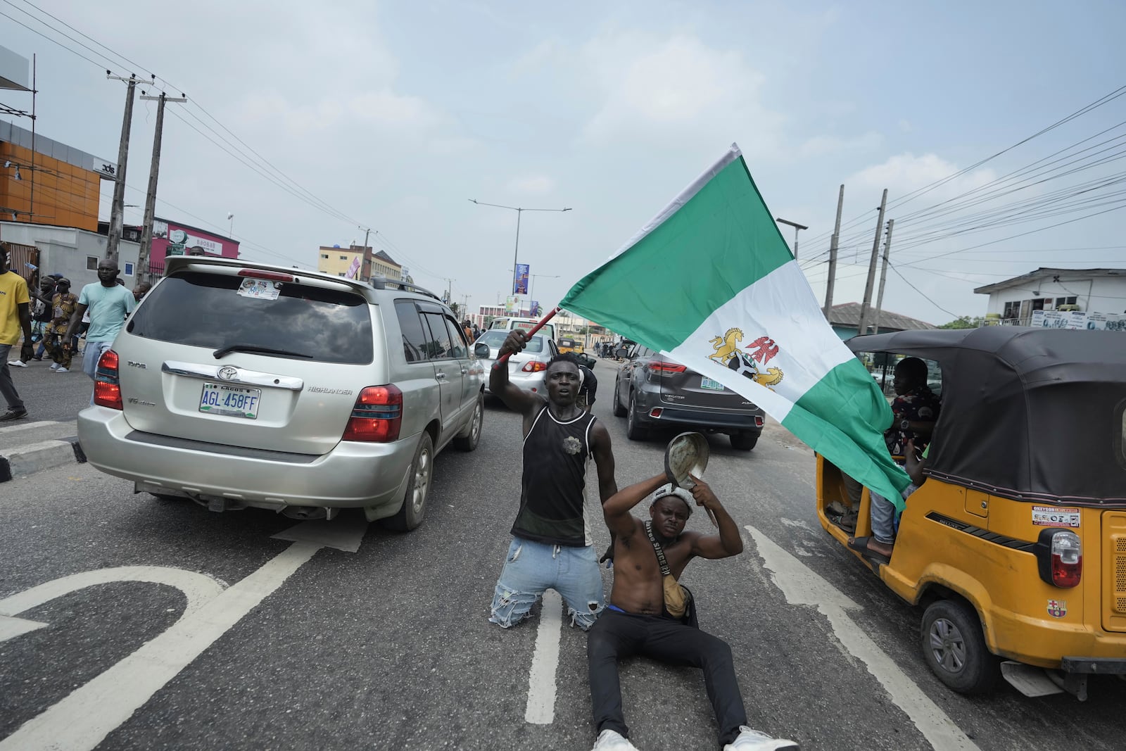 People attend anti-government protests on streets of Lagos, Nigeria, Thursday, June 12, 2025. (AP Photo/Sunday Alamba)