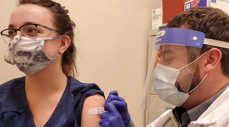 Drug Mart Chief Pharmacist Christopher Bowman provides an immunization in Enon. CONTRIBUTED