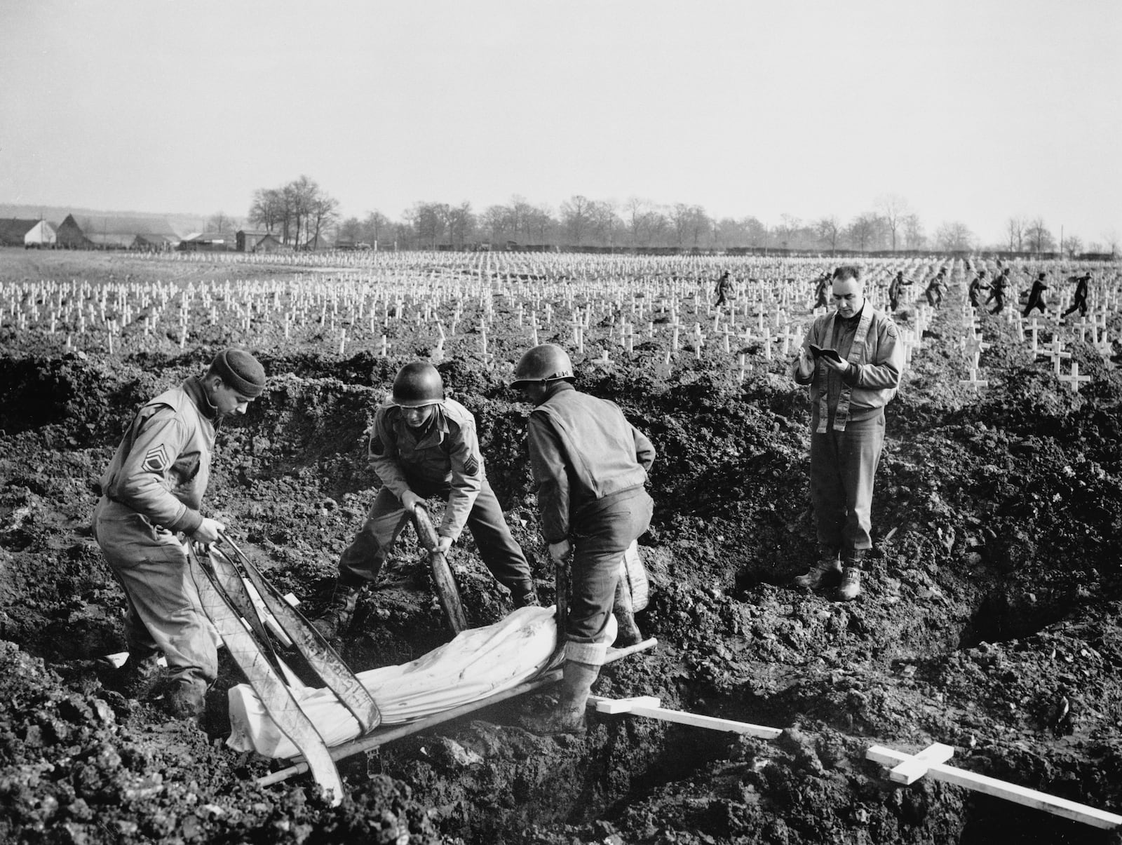FILE - An American soldier, identified as Patsy Caliendo, is laid to rest in the largest Allied military cemetery on the Western Front March 14, 1945, in Henri-Chapelle, Belgium. (AP Photo/William C. Allen, File)